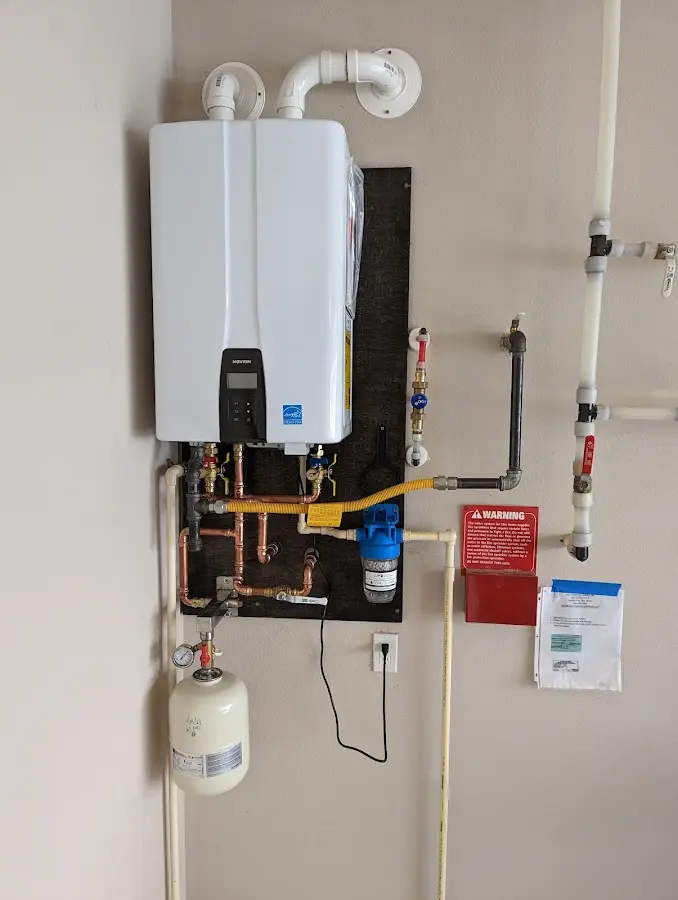 Professional plumber installing copper piping in a Grass Lake home